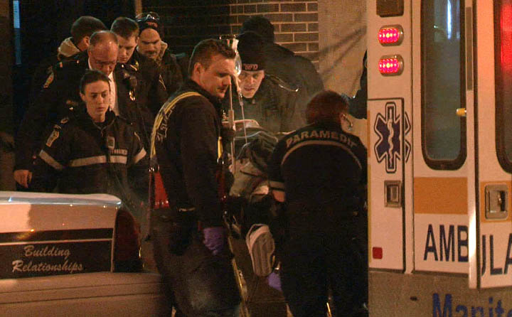 Paramedics load an injured man into an ambulance outside Teaser's Burlesque Palace early Tuesday.