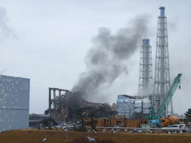 FILE - In this March 21, 2011 file photo released by Tokyo Electric Power Co. (TEPCO), smoke rises from the Unit 3 reactor of the tsunami-damaged Fukushima Dai-ichi nuclear plant in Okuma town, Fukushima prefecture, northeastern Japan.