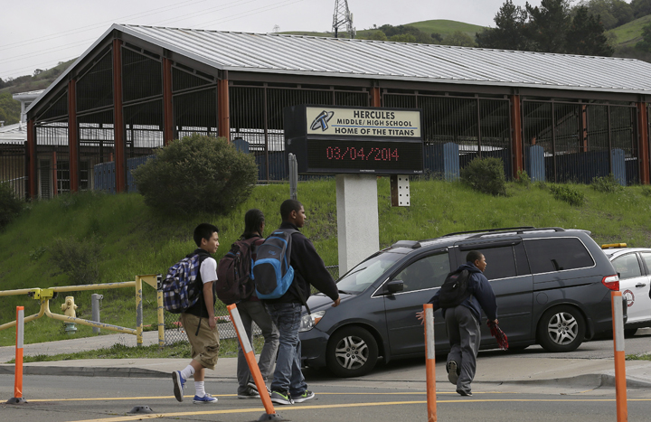 Students cross the street toward the Hercules Middle-High School campus in Hercules, Calif., Tuesday, March 4, 2014.