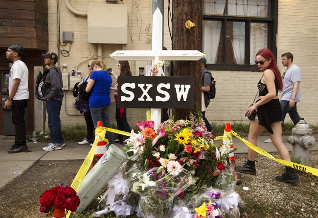 In this March 15, 2014 file photo, a cross and flowers are outside The Mohawk in Austin, Texas, as a memorial to the people who died after being struck by a drunken driving suspect during the South By Southwest festival. On Thursday, March 27, 2014, police say a fourth person, DeAndre Tatum has died.