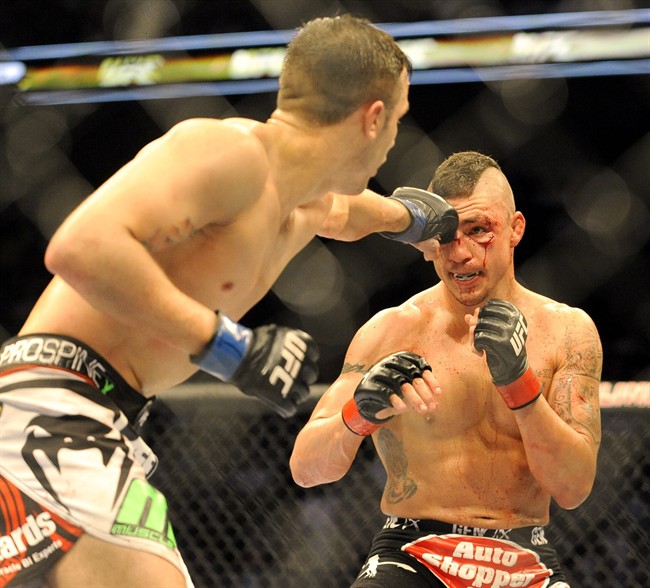 Myles Jury lands a punch on Diego Sanchez during a UFC 171 mixed martial arts lightweight bout, Saturday, March. 15, 2014, in Dallas. Jury won by decision. The Saskatchewan government has proclaimed legislation to set up a commission to sanction professional combative sporting events in the province.