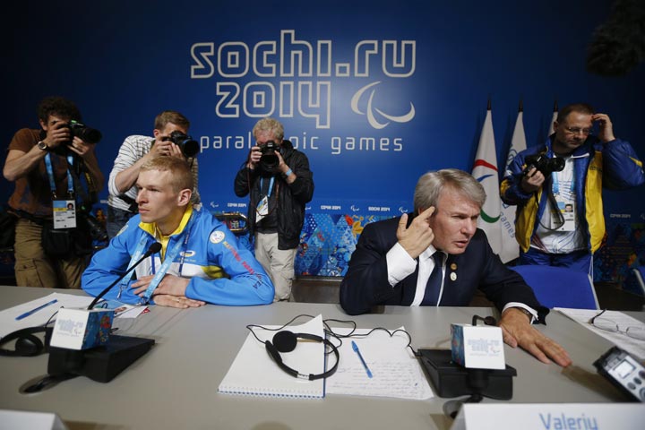Ukrainian Paralympic athlete Grygorii Vovchinskyi, left, looks on as President of the National Paralympic Committee of Ukraine Valeriy Sushkevich answers a question during a press conference ahead of the opening ceremony of the 2014 Winter Paralympics in Sochi, Russia, Friday, March 7, 2014. 