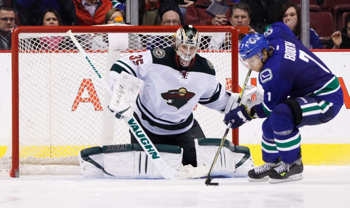 VANCOUVER, BC - FEBRUARY 28: Goaltender Darcy Kuemper #35 of the Minnesota Wild makes a save against David Booth #7 of the Vancouver Canucks during the shootout of their NHL game at Rogers Arena on February 28, 2014 in Vancouver, British Columbia, Canada. (Photo by Ben Nelms/Getty Images).