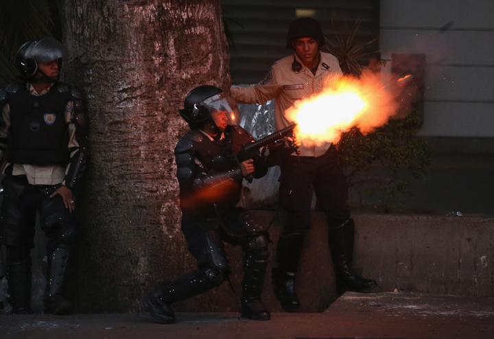 Venezuelan national police fire tear gas at anti-government protesters on March 6, 2014 in Caracas, Venezuela.