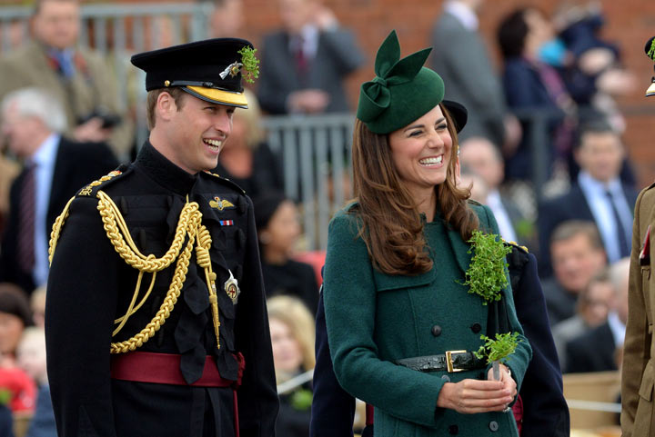 Britain's Prince William, the Duke of Cambridge (L) and Catherine, Duchess of Cambridge (R) look on while visiting the Irish Guards during a St Patrick's Day parade in Mons Barracks in Aldershot on March 17, 2014. 