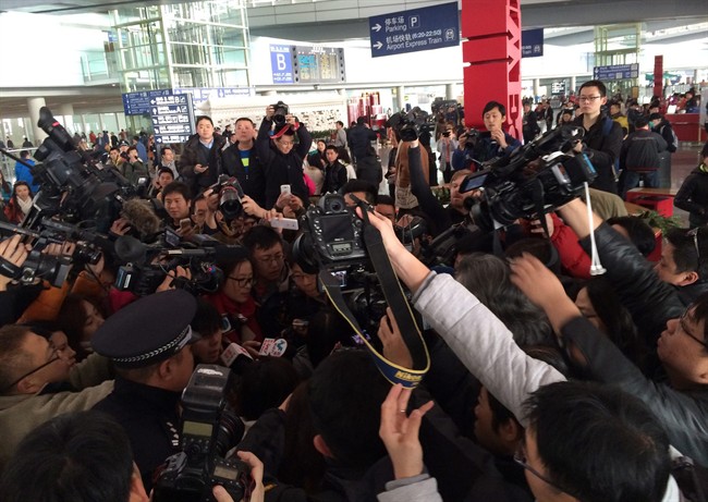 In this photo released by China's Xinhua News Agency, reporters crowd at Terminal 3 of Beijing Capital International Airport in Beijing, China Saturday, March 8, 2014 following a report that a Malaysia Airlines Boeing 777-200 lost contact on a flight from Kuala Lumpur to Beijing. (AP Photo/Xinhua, Luo Xiaoguang).