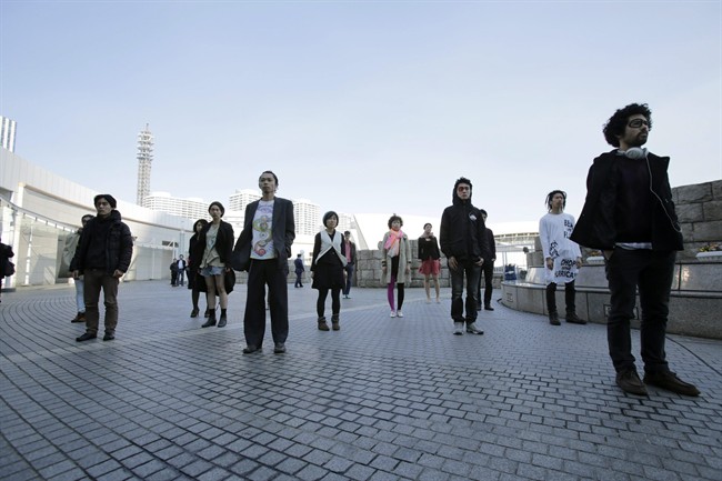 Demonstrators participate in a silence protest in front of a conference hall where the Intergovernmental Panel on Climate Change is meeting in Yokohama, near Tokyo, Monday, March 31, 2014. 