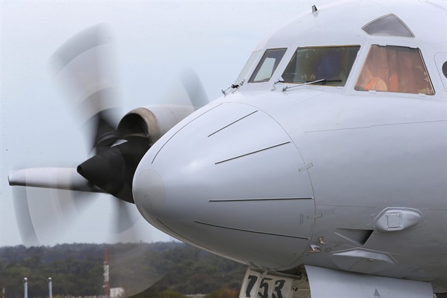 A Royal Australia Air Force AP-3C Orion runs its engines for maintenance during a no fly day in the search for missing Malaysia Airlines flight MH370 in Perth, Australia, Tuesday, March 25, 2014.