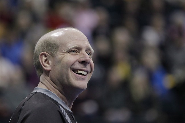Skip Kevin Martin smiles during the first end of the men's semi-final against John Morris at the 2013 Roar of the Rings Canadian Olympic Curling Trials in Winnipeg, Dec. 7, 2013. Former Olympic champion Martin is retiring from curling.