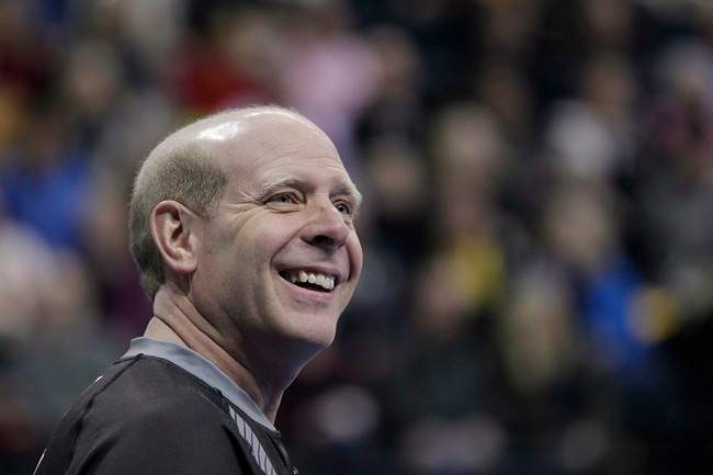 Skip Kevin Martin smiles during the first end of the men's semi-final against John Morris at the 2013 Roar of the Rings Canadian Olympic Curling Trials in Winnipeg, Saturday, December 7, 2013. Former Olympic champion Martin is retiring from curling.