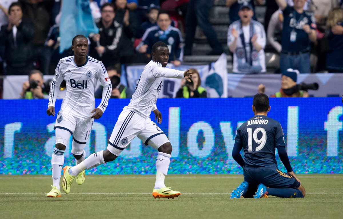 Vancouver Whitecaps' Kekuta Manneh, centre, of Gambia, celebrates after scoring the tying goal as teammate Darren Mattocks, left, of Jamaica, and Los Angeles Galaxy's Juninho, of Brazil, look on during second half MLS soccer action in Vancouver, B.C., on Saturday April 19, 2014. THE CANADIAN PRESS/Darryl Dyck.