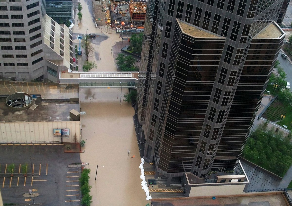 Rising water floods the Bow River in downtown Calgary on June 21, 2013. As many as 100,000 people have been forced from their homes.