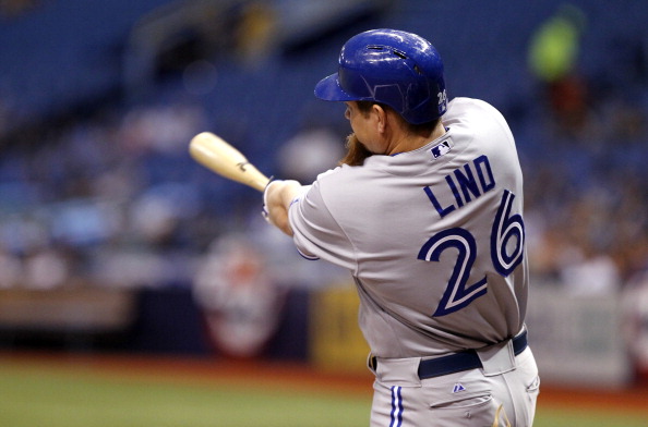 Adam Lind #26 of the Toronto Blue Jays follows through on his three-run home run during the first inning of a game against the Tampa Bay Rays on April 1, 2014 at Tropicana Field in St. Petersburg, Florida. 