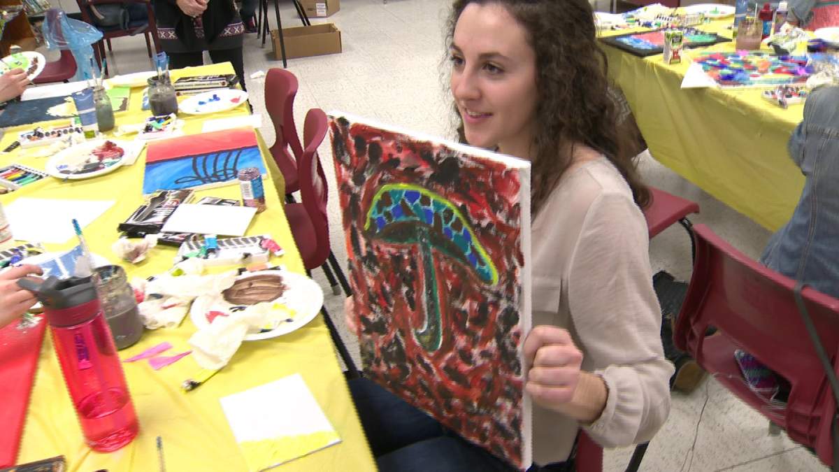Students at Harrison Trimble show off their pieces of art during their art therapy class, launched last spring.