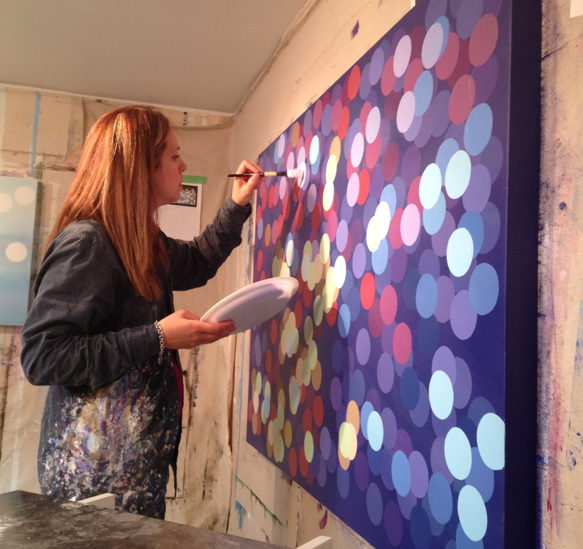 Founder of Buy Art Not Kids Rachelle Kearns works on an upcoming piece to raise funds for children in need.