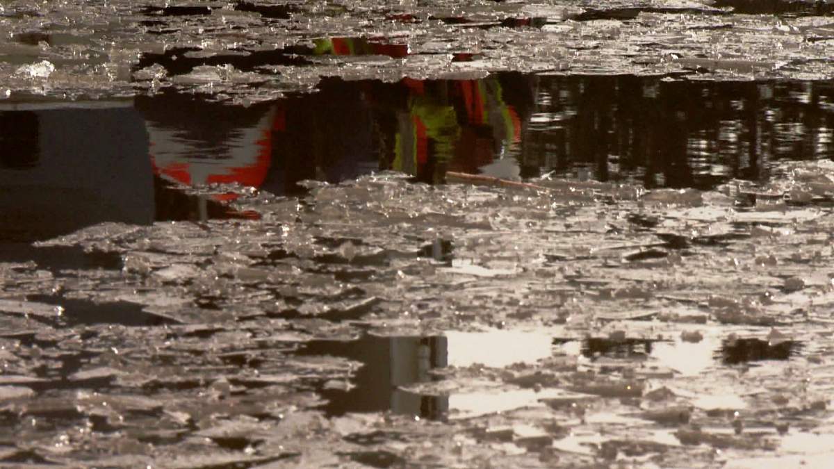 Melted snow pools at a storm drain as temperatures rise in Calgary during the spring of 2014. 