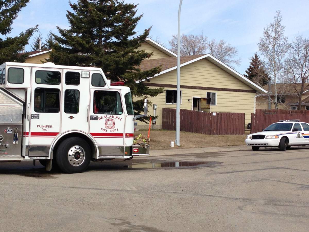 One door of the Beaumont home was clearly scorched and other damage visible after the flames were extinguished. 