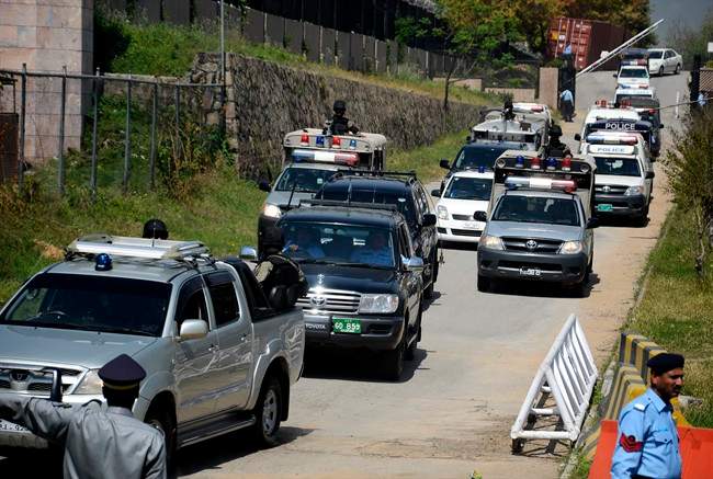 The convoy of former Pakistani President Pervez Musharraf escorted by paramilitary troops, leaves the special court in Islamabad, Pakistan, Monday, March 31, 2014. 