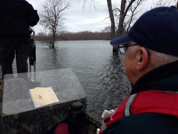 Don Bishop of Darlings Island takes a boat home. Road is closed due to flooding and road damage.