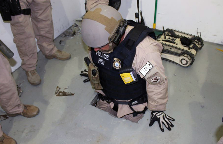 This image provided by the U.S. Immigration and Customs Enforcement (ICE) agency shows an agent examining one of two tunnels discovered April 1, 2014 in San Diego’s Otay Mesa industrial park.