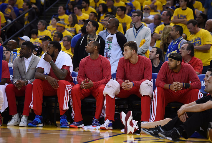 Los Angeles Clippers players sit on the bench wearing their warm-up tops inside out against the Golden State Warriors in Game Four of the Western Conference Quarterfinals during the 2014 NBA Playoffs at ORACLE Arena on April 27, 2014 in Oakland, California. The players wore theirs warm up this way in protest of owner Donald Sterling’s alleged racially insensitive remarks.