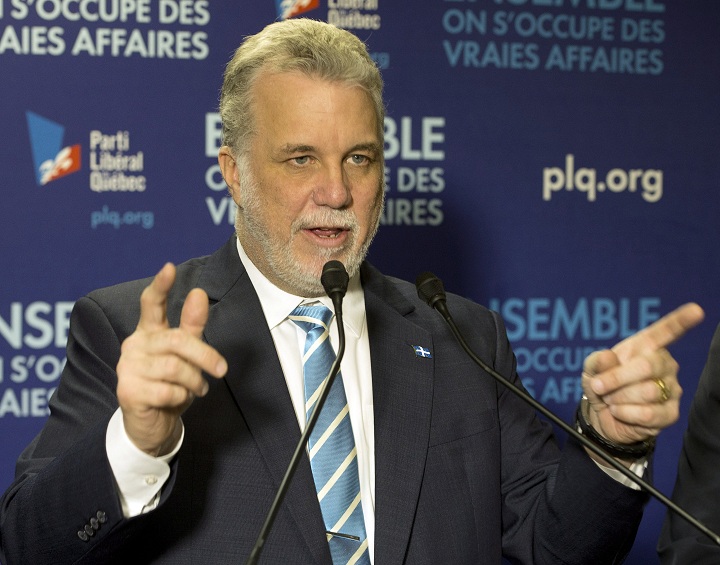 Quebec Liberal leader Philippe Couillard speaks to supporters at the local riding office Thursday, April 3, 2014 while campaigning in Granby, Que. Quebecers will vote in a provincial election April 7, 2014.