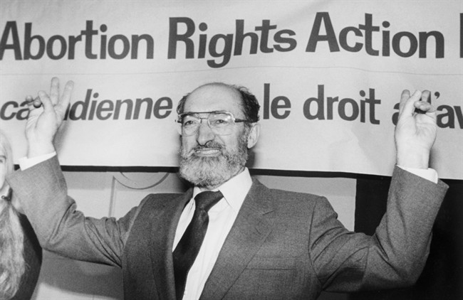 Dr. Henry Morgentaler raises his arms in victory at a news conference in Toronto on Jan. 28, 1988.