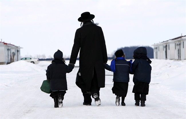 Members of the Lev Tahor walk down a street in Chatham, Ont., on March 5, 2014.