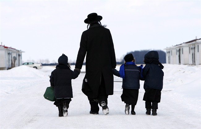 Members of the Lev Tahor walk down a street in Chatham, Ont., on March 5, 2014. 