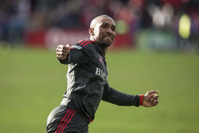 Toronto FC 's Jermain Defoe celebrates after scoring against D.C. United during second half MLS action in Toronto on March 22, 2014. The Toronto FC injury list continues to grow. Manager Ryan Nelsen says striker Jermain Defoe (hamstring) and defender Doneil Henry (knee) are definitely out for Saturday's home game against the Colorado Rapids. THE CANADIAN PRESS/Chris Young.