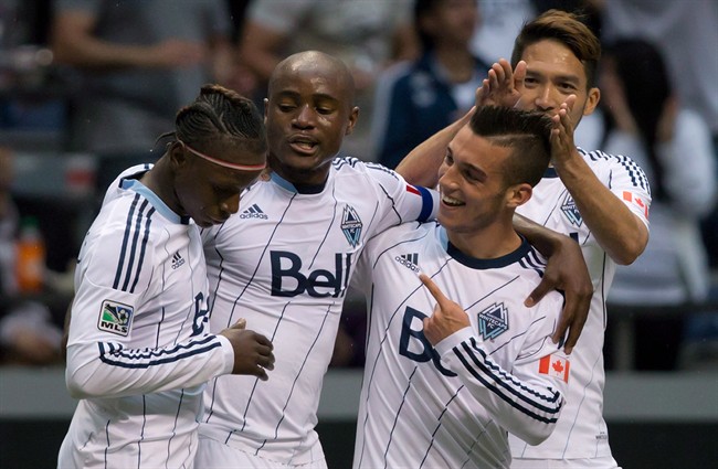 Vancouver Whitecaps' Darren Mattocks, of Jamaica, from left to right, Nigel Reo-Coker, of England, Russell Teibert and Jun Marques Davidson, of Japan, celebrate in this file photo. 