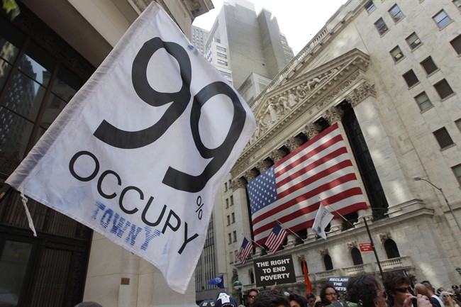 Occupy Wall Street protestors walk past the New York Stock Exchange in 2012.