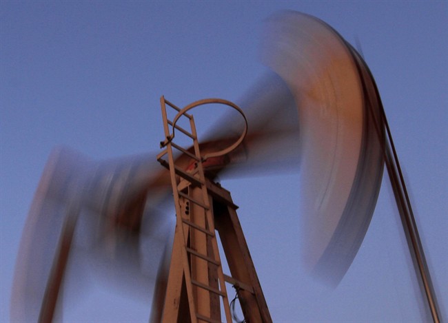 An oil pump works at sunset March 7, 2013, in the desert oil fields of Sakhir, Bahrain.