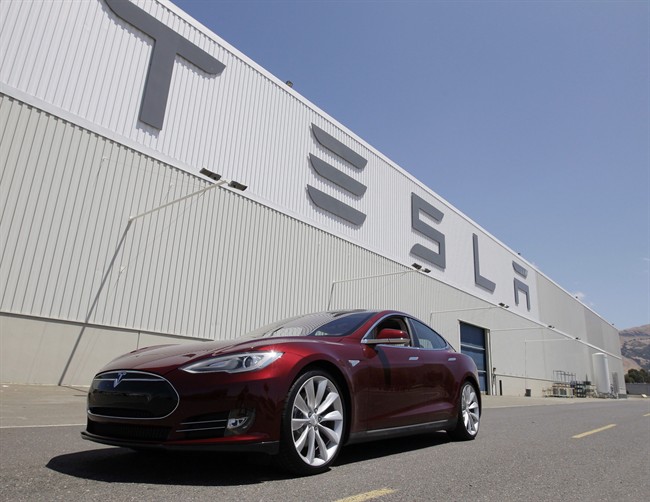 A Tesla Model S drives outside the Tesla factory in Fremont, Calif. on June 22, 2012. 