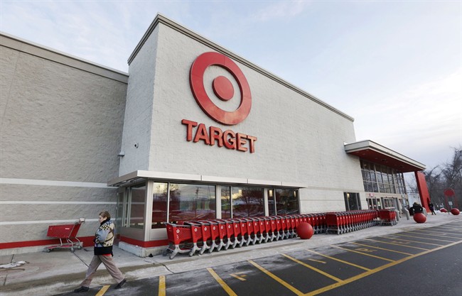 A passer-by walks near an entrance to a Target retail store in Watertown, Mass. on Dec. 19, 2013. 