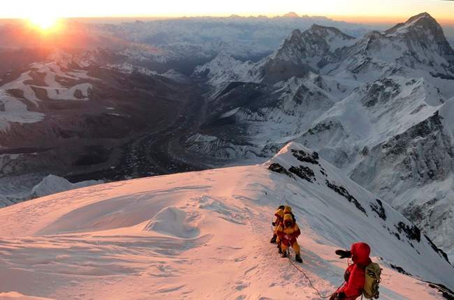  In this May 18, 2013 file photo released by mountain guide Adrian Ballinger of Alpenglow Expeditions, climbers make their way to the summit of Mount Everest, in the Khumbu region of the Nepal Himalayas. An avalanche swept down a climbing route on Mount Everest early Friday, April 18, killing at least 12 Nepalese guides and leaving three missing in the deadliest disaster on the world's highest peak. (AP Photo/Alpenglow Expeditions, Adrian Ballinger, File) .