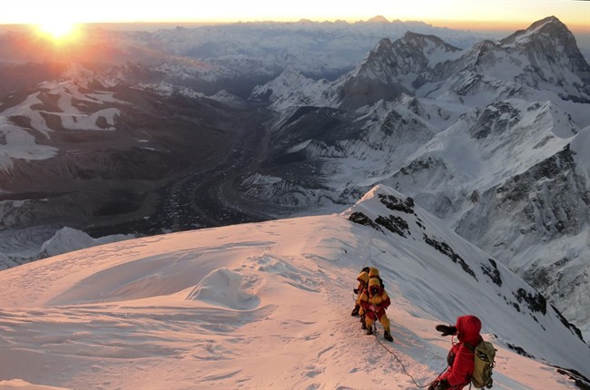  In this May 18, 2013 file photo released by mountain guide Adrian Ballinger of Alpenglow Expeditions, climbers make their way to the summit of Mount Everest, in the Khumbu region of the Nepal Himalayas. An avalanche swept down a climbing route on Mount Everest early Friday, April 18, killing at least 12 Nepalese guides and leaving three missing in the deadliest disaster on the world's highest peak. (AP Photo/Alpenglow Expeditions, Adrian Ballinger, File) .