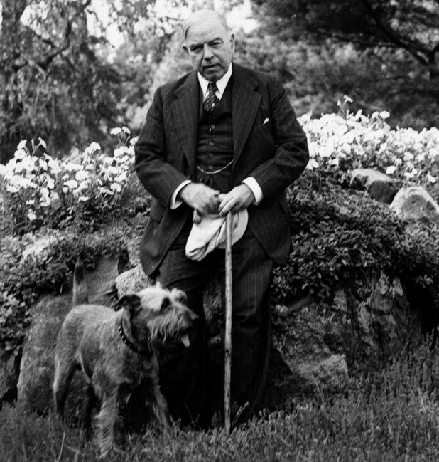 Prime Minister William Lyon Mackenzie King poses with his dog Pat in an archival photo.