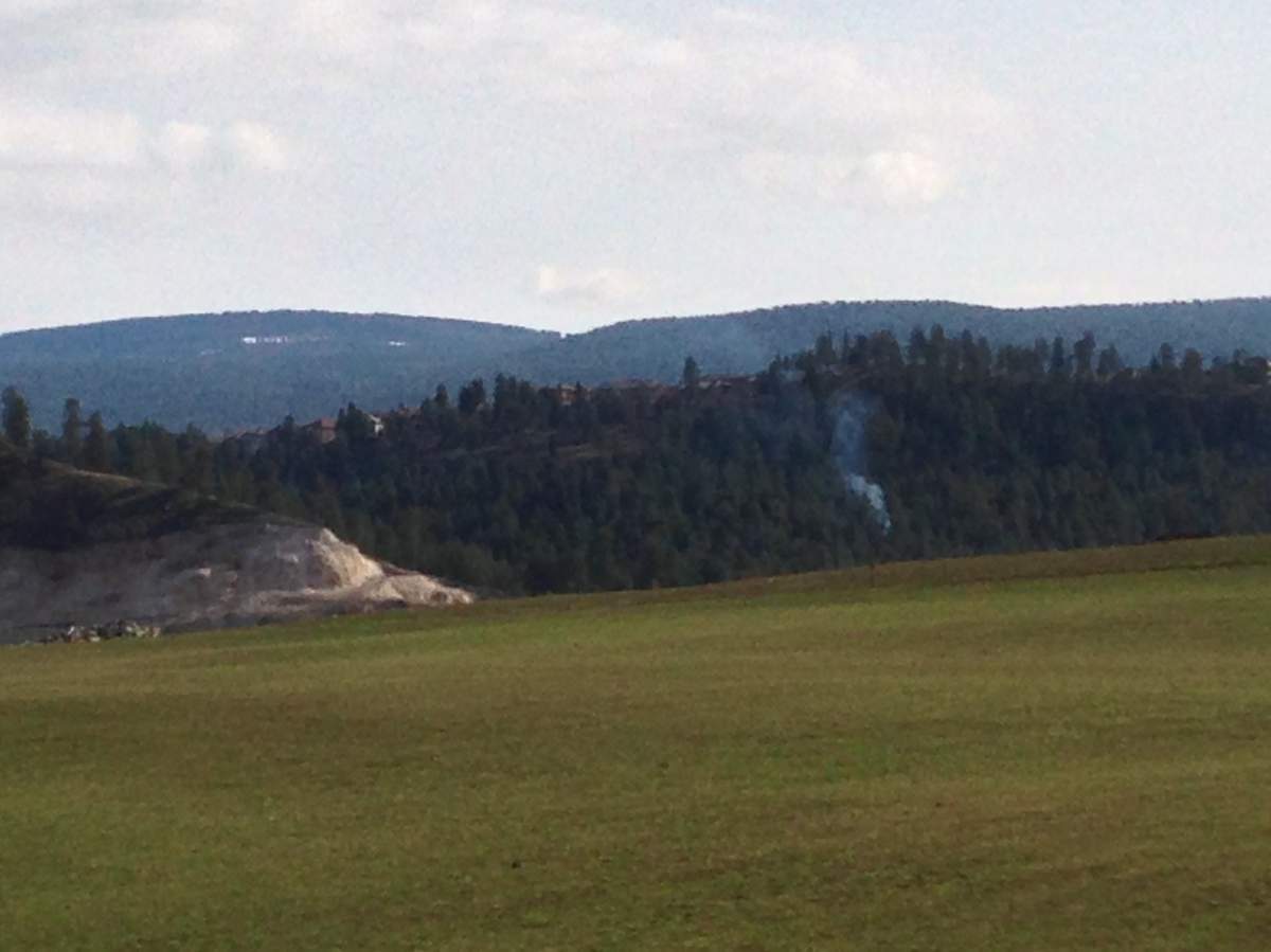 Smoke is rising from near the Kelowna Landfill, but it originates from private property where a permitted burn is underway. 