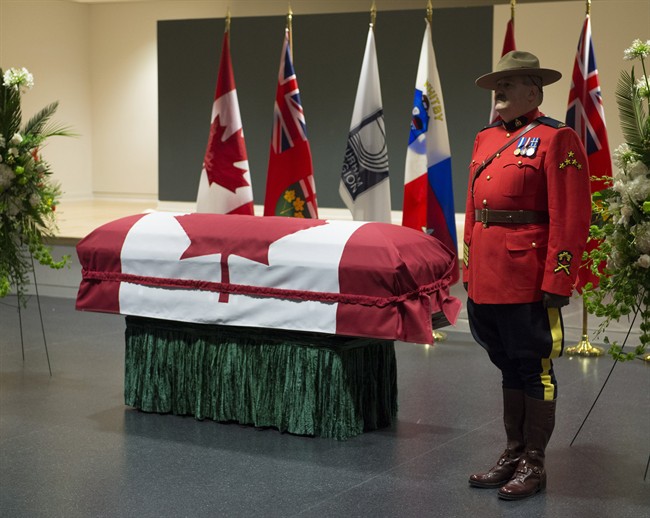 RCMP officers stand next to Jim Flaherty's casket during visitation at the Abilities Centre in Whitby, Ont., on Tuesday, April 15, 2014. THE CANADIAN PRESS/Frank Gunn.