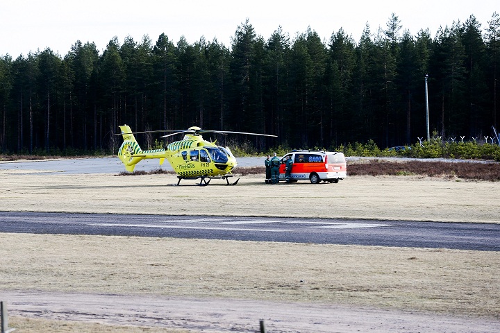 A helicopter and an ambulance are seen at the Jamijarvi Airfield, southwest Finland, on Sunday April 20, 2014. 