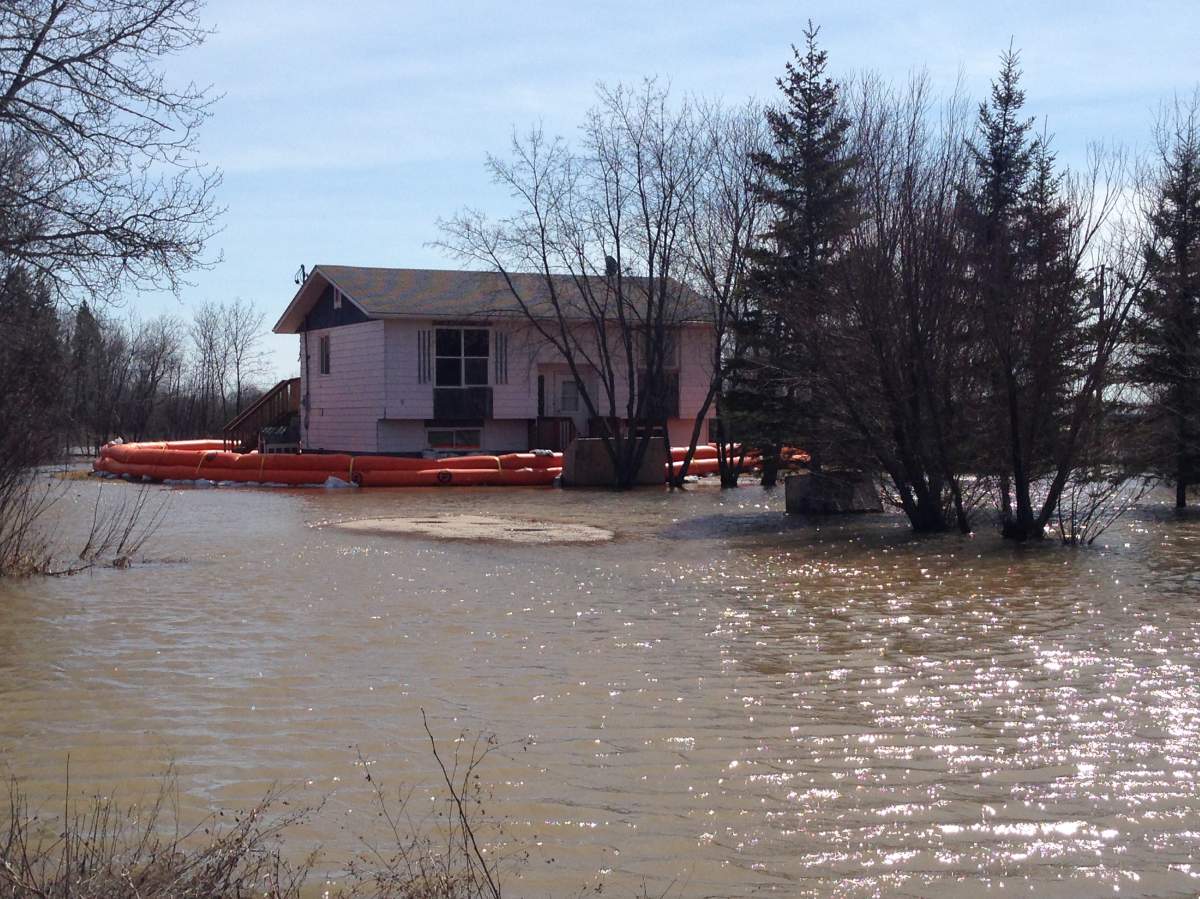 Evacuated home in Peguis First Nation are surrounded by water.