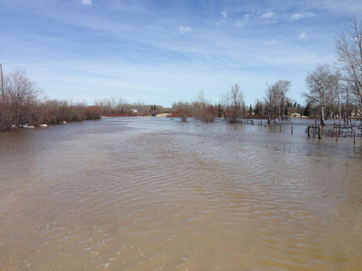 A car was abandoned after it couldn’t cross a road with flooded with over a foot of water.