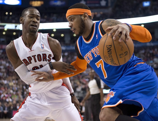 Toronto Raptors guard Terrence Ross (31) defends against New York Knicks forward Carmelo Anthony during first half NBA action in Toronto on Friday April 11, 2014.