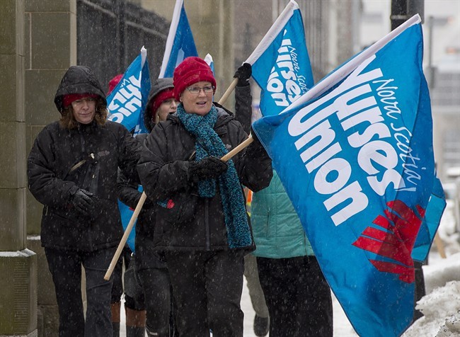 Nurses protest against the introduction of the Essential Health and Community Services Act outside the legislature in Halifax on Tuesday, April 1, 2014. 