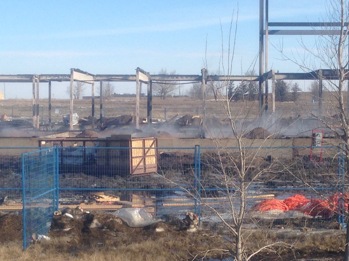 The scene, near Diefenbaker Road and Pasqua Street North, was still smouldering at 9:30 a.m. Saturday morning.