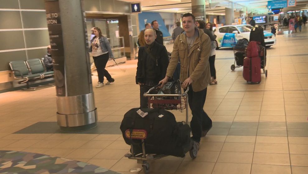 James Birkbeck (accompanied by his cousin on the left) getting ready to head back to the U.K. Wednesday afternoon.