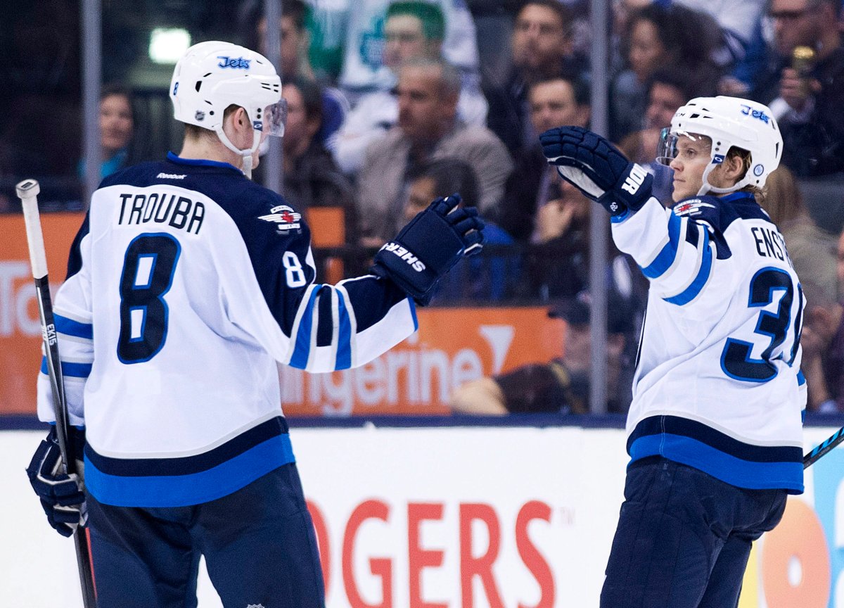 Winnipeg Jets defenceman Tobias Enstrom, right, celebrates his goal with teammate Jacob Trouba, left, while playing against the Toronto Maple Leafs during second period NHL hockey action in Toronto on Saturday, April 5, 2014. 