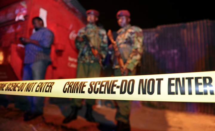Security forces secure the scene around a vehicle explosion outside a police station in central Nairobi, Kenya, Wednesday, April 23, 2014. 