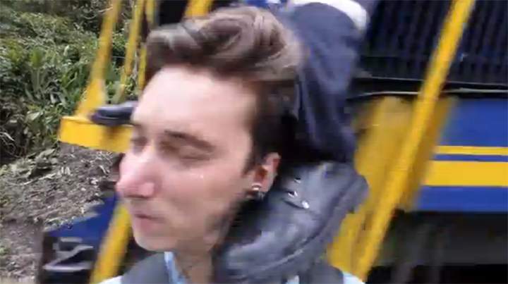 Video still of Jared Frank being kicked in the head by a train conductor in Peru.